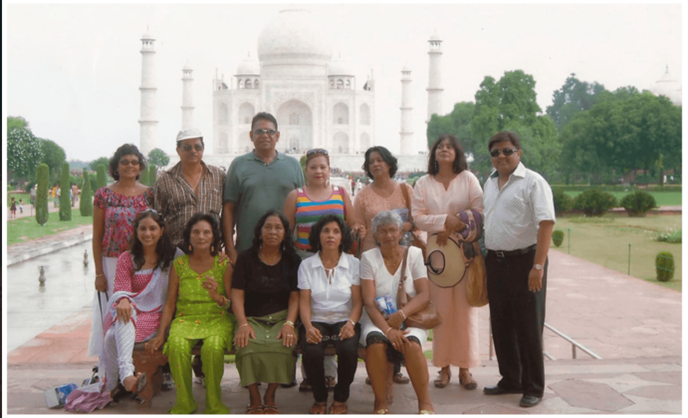 A group of travellers gathered on the marble terrace in front of the Taj Mahal at Agra.